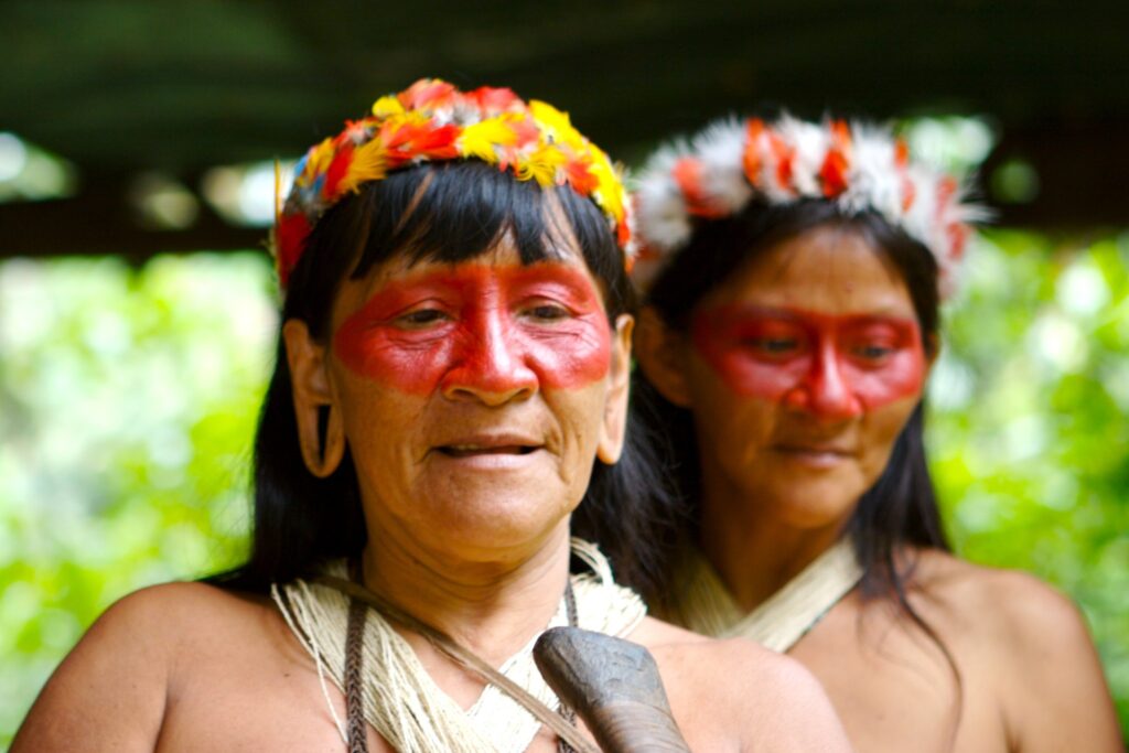 Amazonian Women with face paint and feathers on their hair